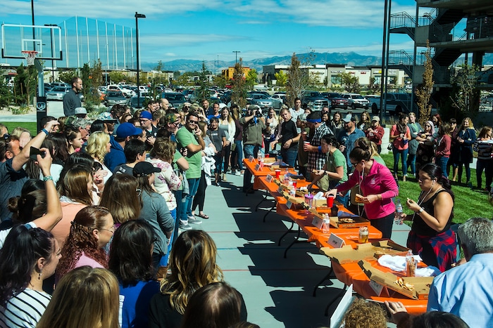 (Chris Detrick | The Salt Lake Tribune) Employees compete in a pizza eating competition during a fundraiser for United Way at CHG Healthcare Wednesday, September 20, 2017.