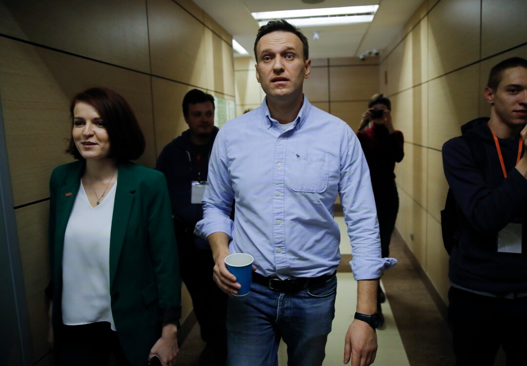 Russian opposition leader Alexei Navalny walks, at his Foundation for Fighting Corruption office, in Russia, Sunday, March 18, 2018. Russians are voting in a presidential election in which Vladimir Putin is seeking a fourth term in the Kremlin. (AP Photo/Pavel Golovkin)