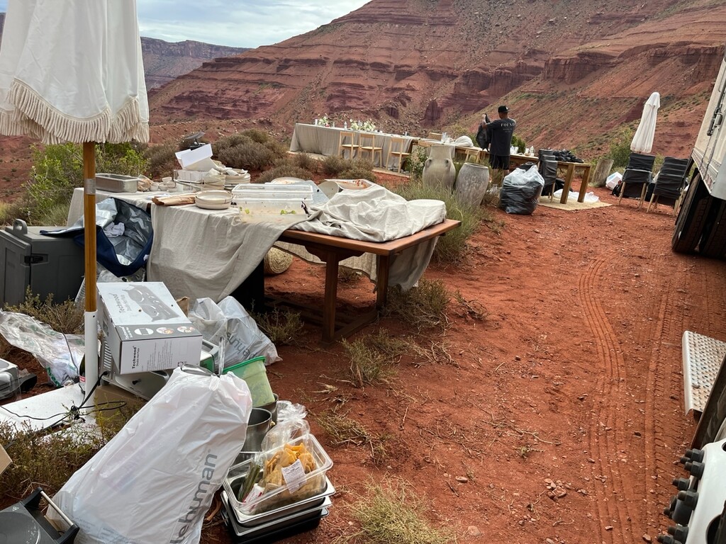(Pamela Gibson) Trash and furniture littered the ridge between Castleton Tower and Adobe Mesa the morning after the wedding.