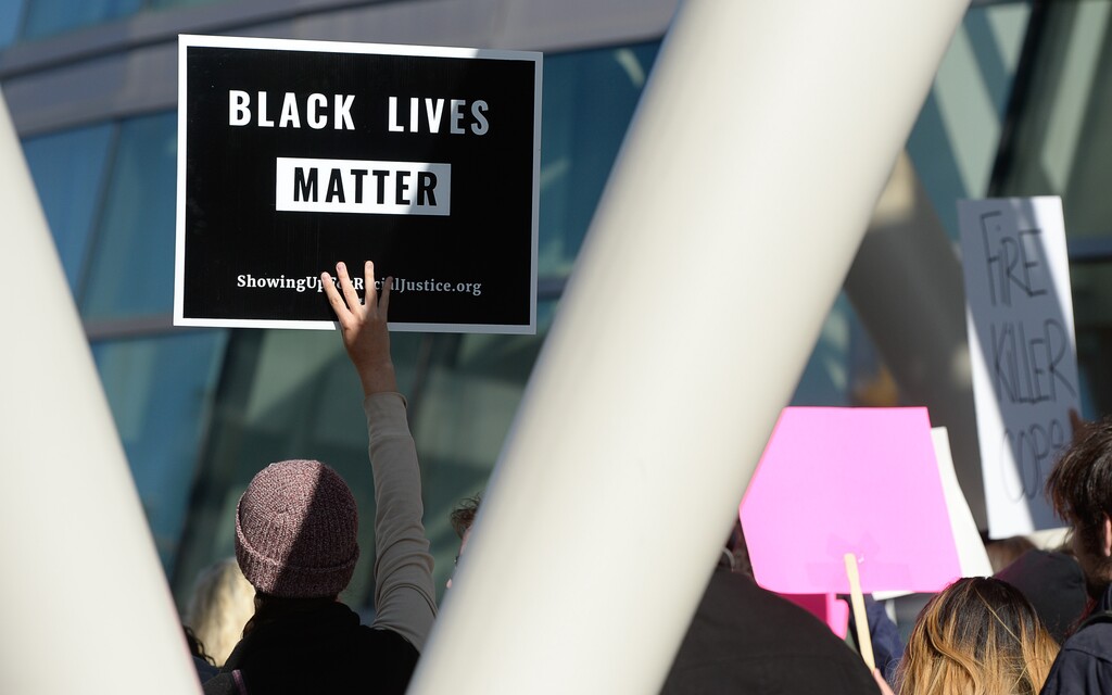 (Francisco Kjolseth | The Salt Lake Tribune) People gather to demand justice for the killing of Patrick Harmon who was shot by police on Aug. 13, when he tried to flee after being stopped on his bicycle. Around 150 people gathered for the rally at the Salt Lake City Public Safety Building on Sunday, Oct. 8, 2017, demanding Salt Lake County district attorney Sim Gill be fired for his "justified," ruling in the case.