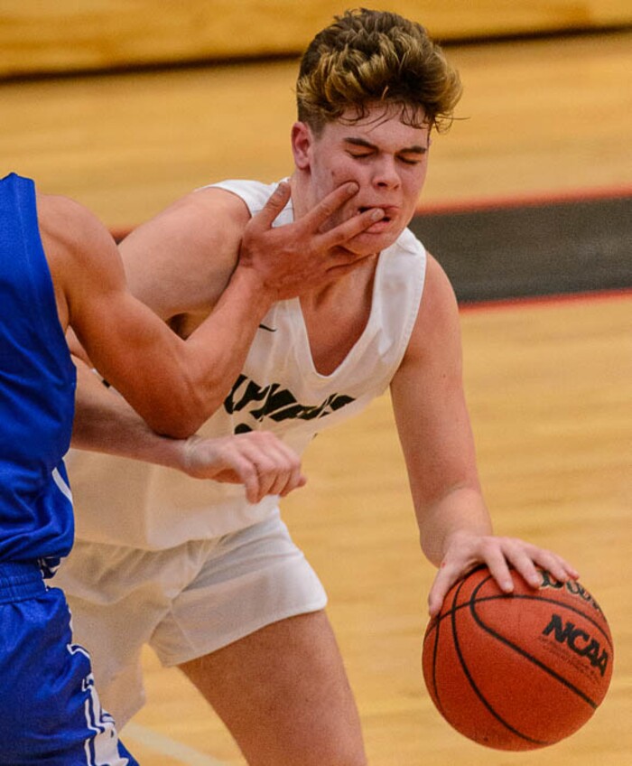 (Trent Nelson | The Salt Lake Tribune) Olympus's Jeremy DowDell gets a taste of Bingham's Dax Milne's finger as Olympus faces Bingham, high school boys' basketball at the Utah Elite 8 tournament in American Fork, Thursday December 7, 2017.