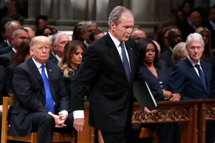 Former President George W. Bush walks past President Donald Trump, first lady Melania Trump, Michelle Obama and former President Bill Clinton to give a eulogy for his father, former President George H.W. Bush during the State Funeral at the National Cathedral, Wednesday, Dec. 5, 2018, in Washington. (AP Photo/Alex Brandon, Pool)