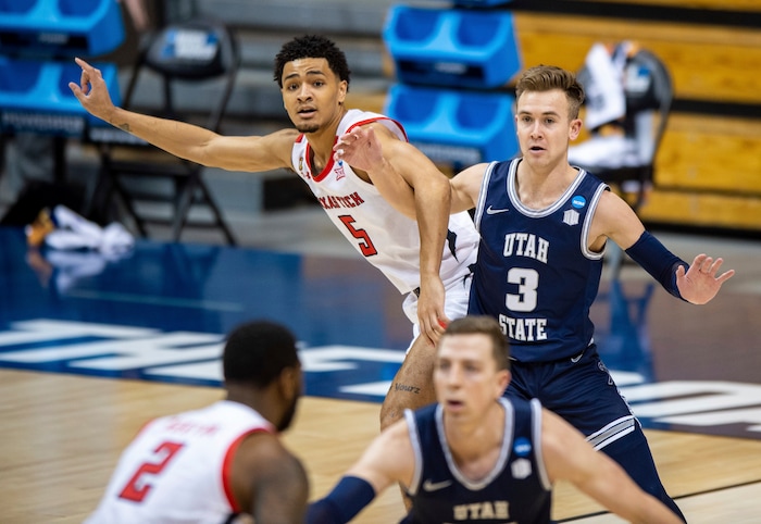 (Doug McSchooler | AP) Texas Tech guard Micah Peavy (5) and Utah State guard Steven Ashworth (3) battle for position under the basket during the first half of a first round game in the NCAA men's college basketball tournament, Friday, March 19, 2021, in Bloomington, Ind.