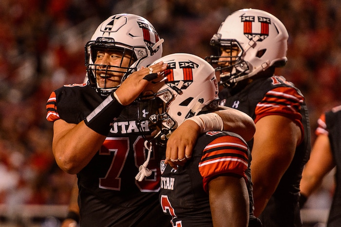 (Trent Nelson | The Salt Lake Tribune)  Utah Utes running back Zack Moss (2) celebrates a touchdown with teammate Utah Utes offensive lineman Jordan Agasiva (79) as the Utah Utes host the San Jose State Spartans, NCAA football at Rice-Eccles Stadium in Salt Lake City, Saturday September 16, 2017.