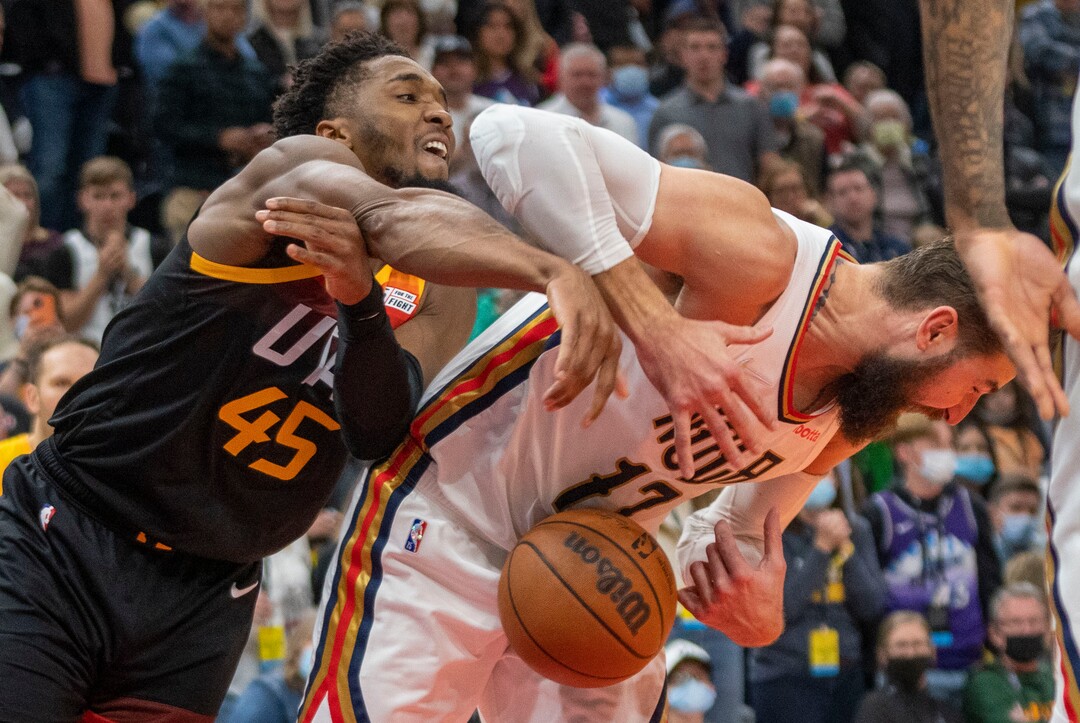 (Rick Egan | The Salt Lake Tribune) Utah Jazz guard Donovan Mitchell (45) battles New Orleans Pelicans center Jonas Valanciunas (17) for a rebound after missing his shot with just seconds left on the clock, in NBA action between the Utah Jazz and the New Orleans Pelicans, at Vivint Arena, in Salt Lake City, on Friday, Nov. 26, 2021.