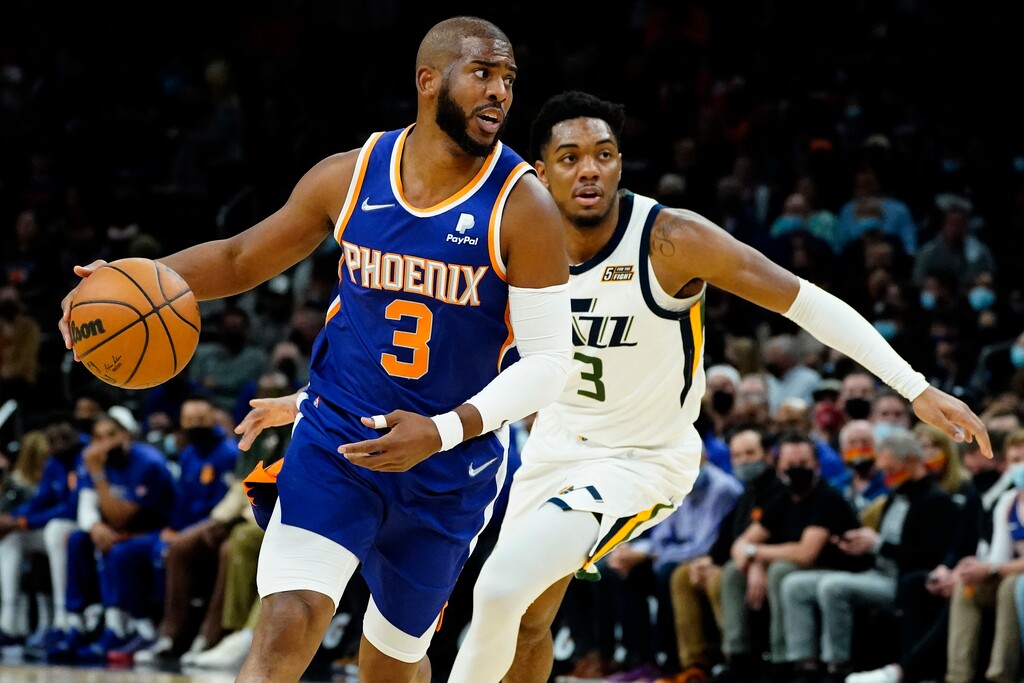Phoenix Suns guard Chris Paul (3) looks to pass as Utah Jazz guard Trent Forrest (3) defends during the first half of an NBA basketball game, Monday, Jan. 24, 2022, in Phoenix. (AP Photo/Matt York)