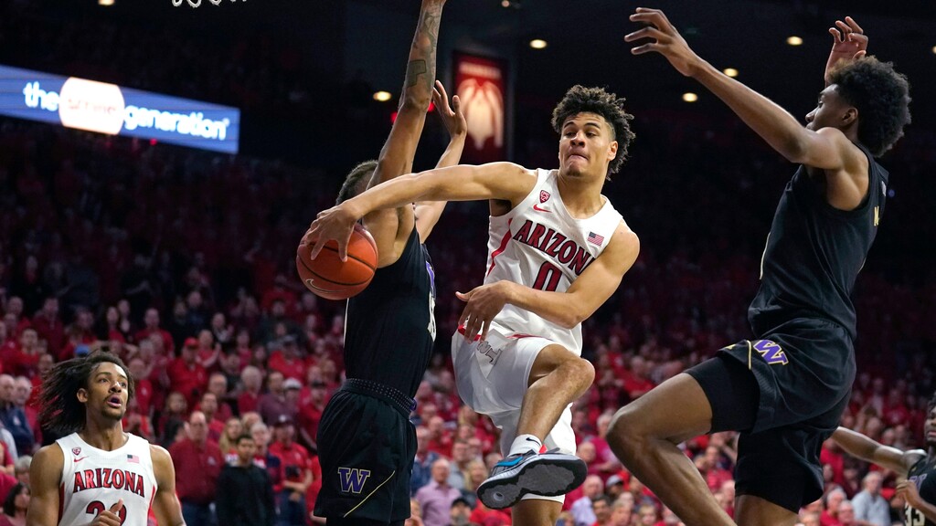 Arizona guard Josh Green (0) tries to pass the ball during the second half of the team's NCAA college basketball game against Washington on Saturday, March 7, 2020, in Tucson, Ariz. Washington won 69-63. (AP Photo/Rick Scuteri)