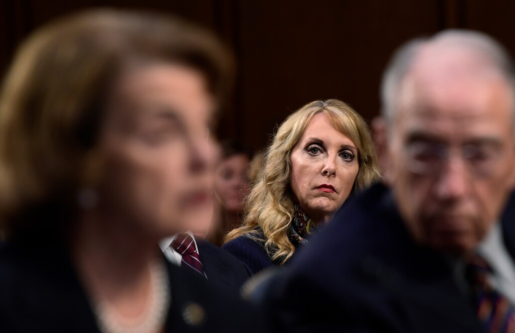 USA Gymnastics President and Chief Executive Officer Kerry Perry, center, listens as Sen. Dianne Feinstein, D-Calif., left, and Sen. Chuck Grassley, R-Iowa, right, speak during a Senate Commerce subcommittee hearing on "Strengthening and Empowering U.S. Amateur Athletes," on Capitol Hill in Washington, Tuesday, July 24, 2018. (AP Photo/Susan Walsh)