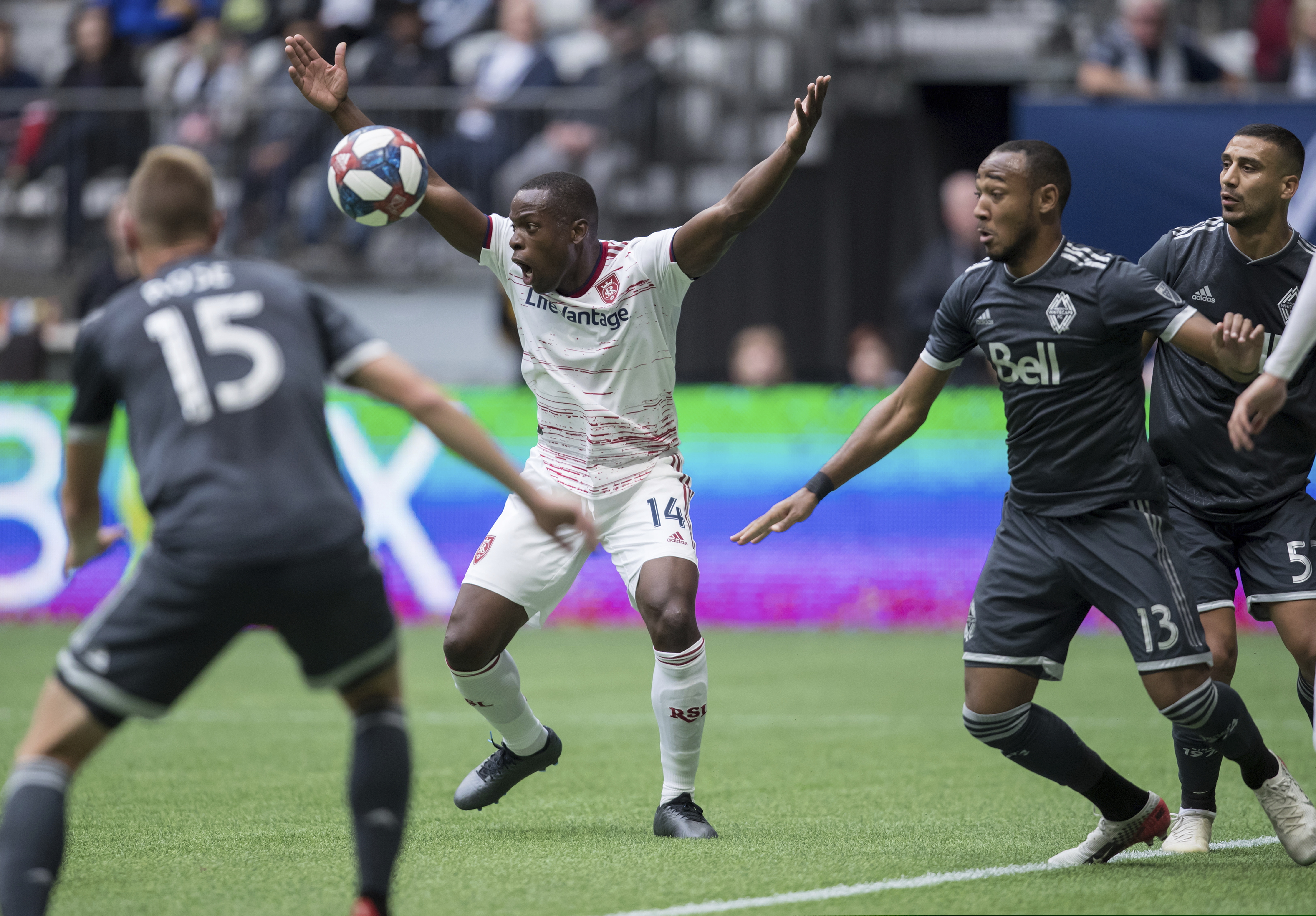 Real Salt Lake's Nedum Onuoha (14) reacts to the referee as Vancouver Whitecaps' Derek Cornelius (13) clears the ball away while Andy Rose (15) and Ali Adnan, right, watch during the first half of an MLS soccer game in Vancouver, British Columbia Sunday Oct. 6, 2019. (Darryl Dyck/The Canadian Press via AP)