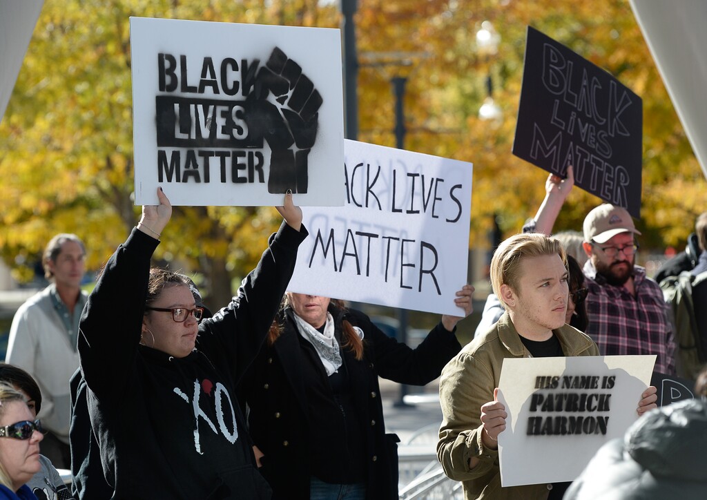 (Francisco Kjolseth  |  The Salt Lake Tribune)  People gather to demand justice for the killing of Patrick Harmon who was shot by police on Aug. 13, when he tried to flee after being stopped on his bicycle. Around 150 people gathered for the rally at the Salt Lake City Public Safety Building on Sunday, Oct. 8, 2017, demanding Salt Lake County district attorney Sim Gill be fired for his "justified," ruling in the case.