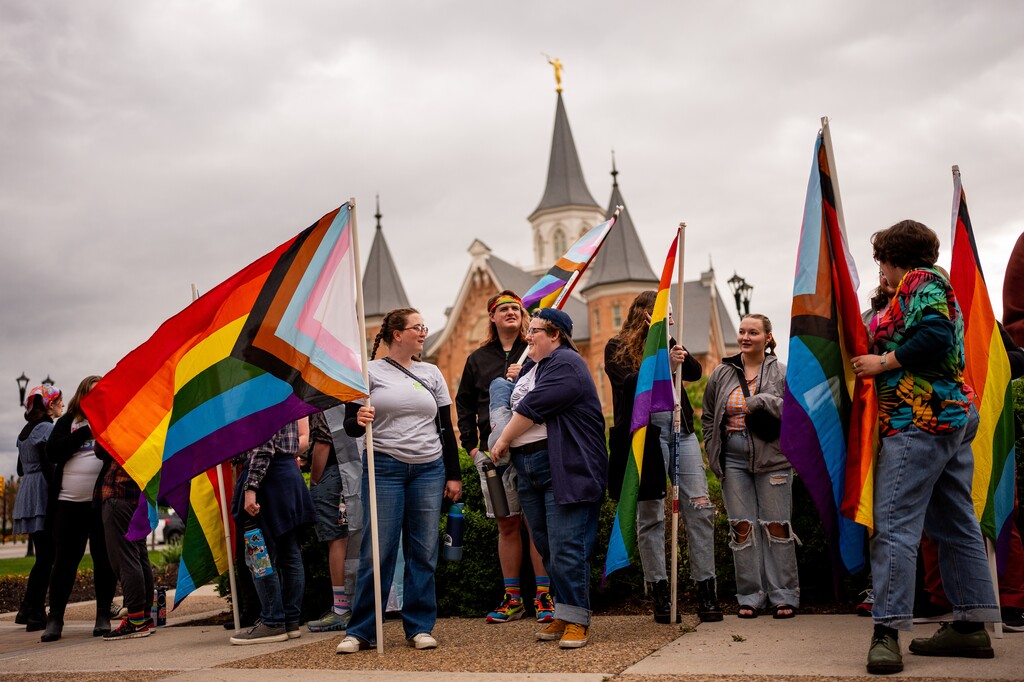 (Spenser Heaps | Special to The Tribune) Students at Brigham Young University gather for the Pride in Progress event, hosted by the Cougar Pride Center, outside the Historic County Courthouse in Provo on Saturday, April 27, 2024. Behind them is the Provo City Center Temple for The Church of Jesus Christ of Latter-day Saints, which sponsors BYU.