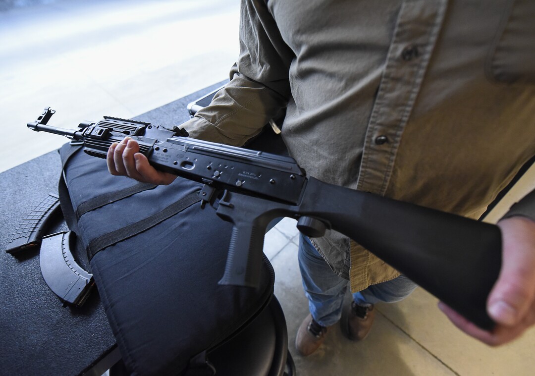 (Francisco Kjolseth  |  The Salt Lake Tribune)  Utah gun rights advocate Clark Aposhian, one of only a handful of Americans who are legally allowed to keep their bump stock, a shooting accessory that alters semi-automatic rifles to fire in quick bursts like a machine gun, demonstrates how it works on an AKM-47 at a gun range in Murray, UT, on Thursday, April 4, 2019. He is challenging the bump stock ban in court, and an appeals court has allowed him to keep his bump stock until his case is resolved in court.