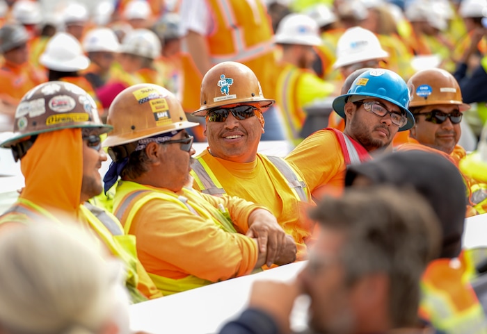 (Leah Hogsten  |  The Salt Lake Tribune) Thousands of workers from all trades attended Wednesday's "topping out" ceremony to raise the last steel beams to a high point on the new Salt Lake City International Airport terminal building, Wednesday, May 23, 2018. The new $485 million terminal building will cover 866,087 square feet and used 11,000 tons of structural steel and 22 miles of steel piles.