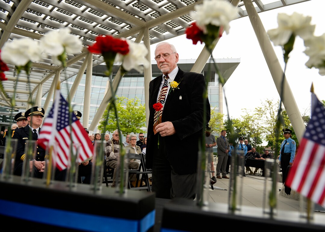 (Leah Hogsten  |  The Salt Lake Tribune)  Bill Thomson carries a carnation in honor of his father-in-law Detective Percy L. Clark who died in the line of duty in February 1973. In honor of Police Week, the Salt Lake City Police Department honored its fallen officers with a memorial service and a 21-gun salute at the Public Safety Building, Thursday, May16, 2019.