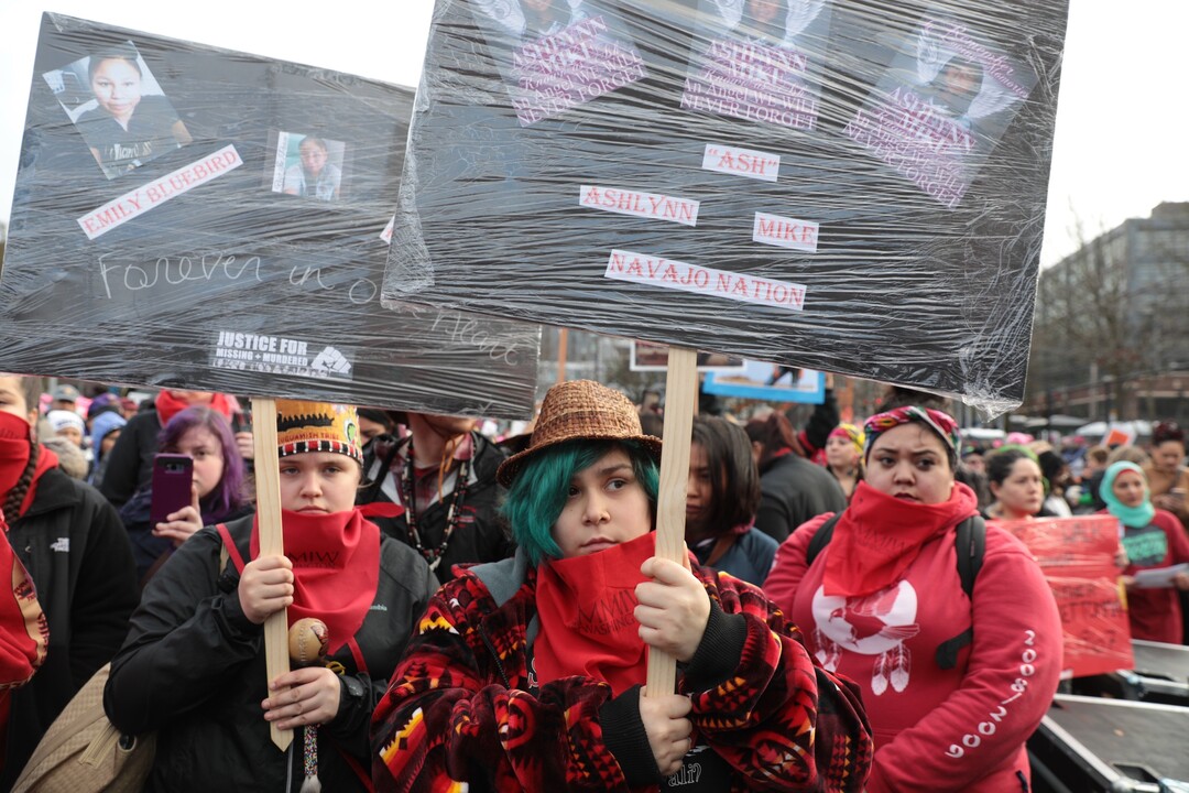 Alawn Chiefstick, center, 14 and Cassady Jackson, 15 of Suquamish listen to the Missing and Murdered Indigenous Women's group speak during the Seattle Women's March, Saturday, Jan. 20, 2018. (Bettina Hansen/The Seattle Times via AP)