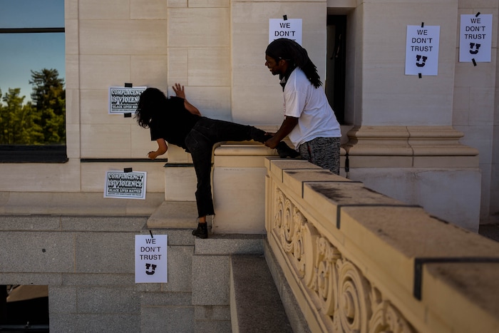 (Trent Nelson | The Salt Lake Tribune) Protesters put up posters at the University of Utah in Salt Lake City on Thursday, Sept. 3, 2020. The protest called for President Ruth Watkins to resign and for the campus police department to be dissolved..