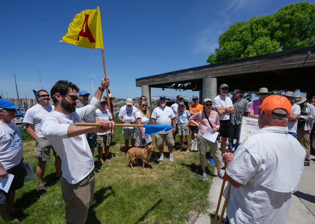 (Francisco Kjolseth  |  The Salt Lake Tribune) Hank Boland, Race Chair for the Great Salt Lake Match Club, left, and Randy Atkins go over flags to indicate the starting stages of the upcoming regatta race with sailboat crews on Saturday, June 15, 2024. The Racefest event returned for the first time in five years due to low lake levels and the pandemic. 