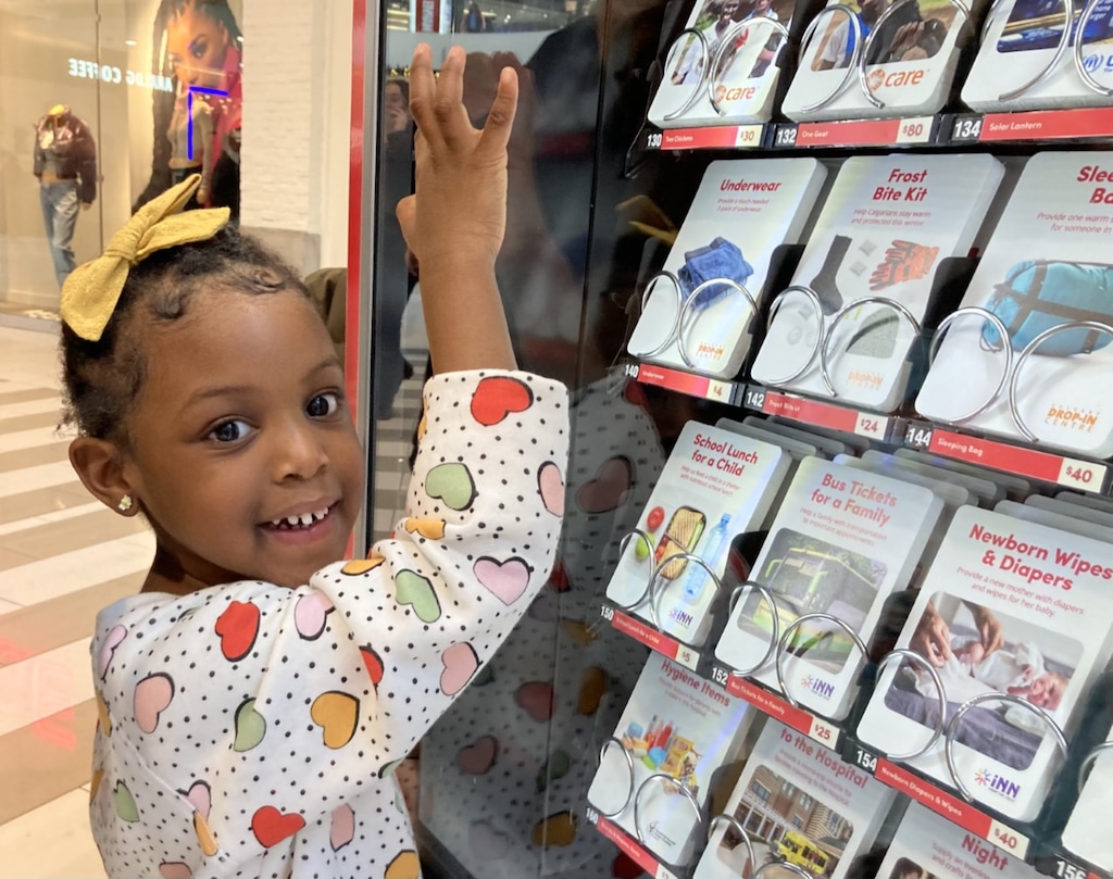 (The Church of Jesus Christ of Latter-day Saints) Keona Ojelade steps up to make her choice at a Giving Machine in Calgary, Alberta, in 2022.