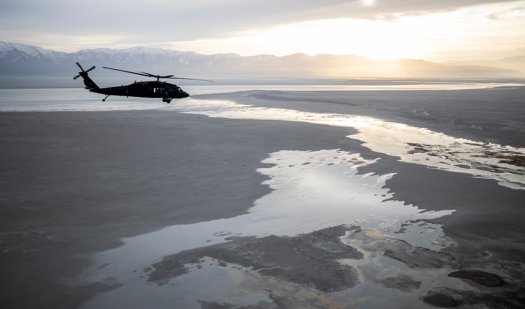 (Scott G Winterton | Pool) A Black Hawk helicopter flies over the Great Salt Lake as Utah lawmakers take an aerial tour of the Great Salt Lake with the Utah National Guard on Tuesday, Feb. 15, 2022.