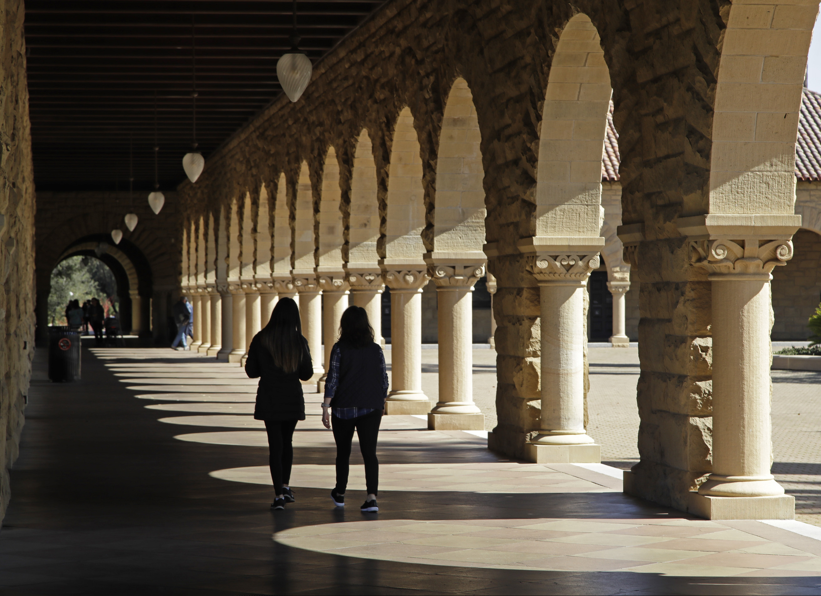 (Ben Margot | AP Photo) Students walk on the Stanford University campus Thursday, March 14, 2019, in Santa Clara, Calif. In the first lawsuit to come out of the college bribery scandal, several students are suing Yale, Georgetown, Stanford and other schools involved in the case, saying they and others were denied a fair shot at admission. The plaintiffs brought the class-action complaint Wednesday, March 13, 2019, in federal court in San Francisco on behalf of themselves and other applicants and asked for unspecified damages.