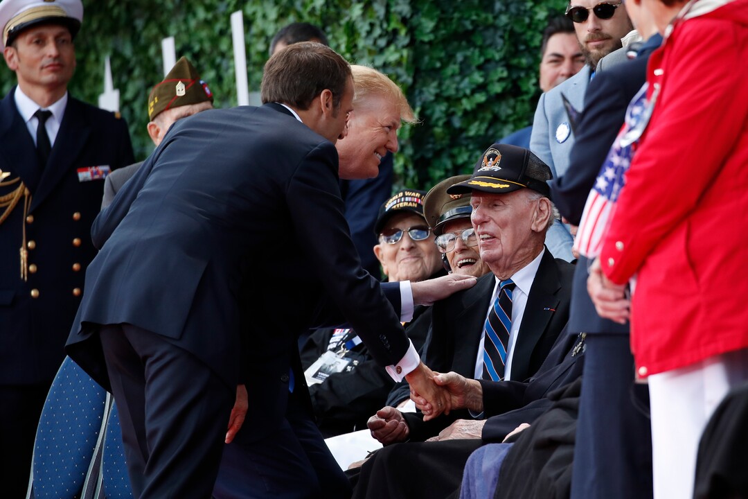 (Alex Brandon | AP) President Donald Trump and French President Emmanuel Macron greet veterans as they arrive to a ceremony to commemorate the 75th anniversary of D-Day at The Normandy American Cemetery, Thursday, June 6, 2019, in Colleville-sur-Mer, Normandy, France.