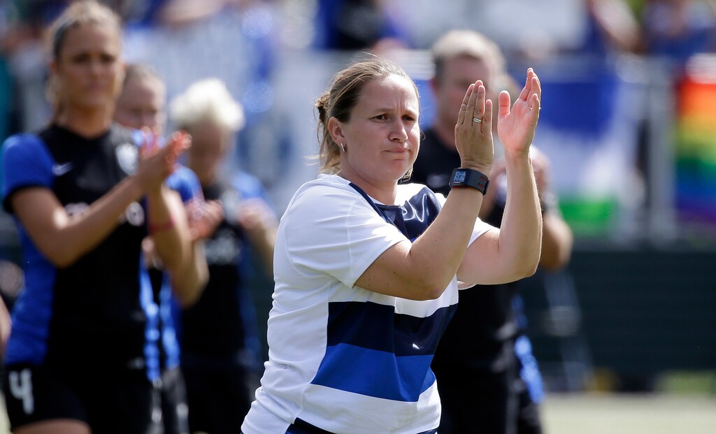 Seattle Reign FC head coach Laura Harvey applauds fans after the team lost to FC Kansas City in the NWSL championship soccer match Sunday, Aug. 31, 2014, in Tukwila, Wash. Kansas City won 2-1. (AP Photo/Elaine Thompson) 