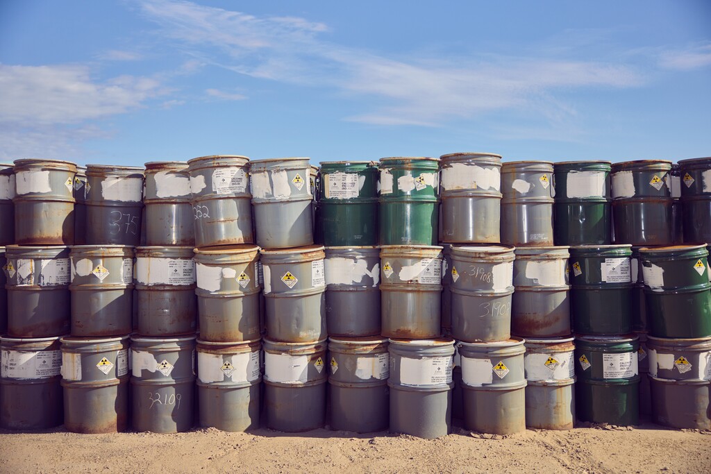 (Jesse Rieser | The New York Times) Radioactive barrels at Energy Fuels' White Mesa Mill in Blanding on Aug. 21, 2024. Uranium miners aim to meet a growing demand for emissions-free energy, though a failure to clean up old sites haunts the industry.