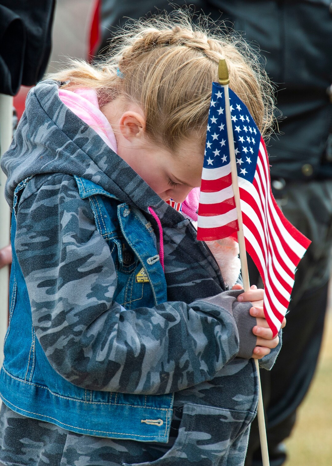 (Rick Egan  |  The Salt Lake Tribune)     Ruthann Reed, 7, bows her head during the dedicatory prayer, at the graveside service for 2nd Lt. Lynn W. Hadfield, who was killed during the Second World War, at Veterans Memorial Park, in Bluffdale. Thursday, March 21, 2019.