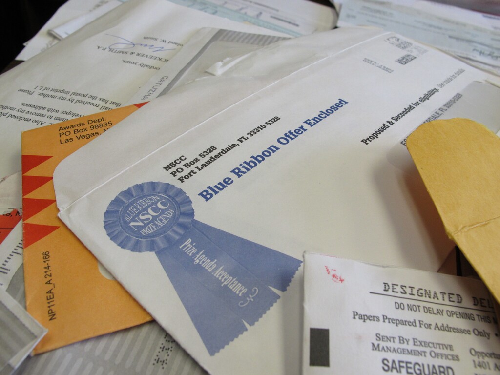 (Allen Breed | AP)This Monday, June 11, 2012, file photo shows piles of official-looking sweepstakes and other mailings spread on a table at the North Carolina Attorney General's office in Raleigh, N.C. According to the National Council on Aging, sweepstakes and lottery scams are among the top 10 financial scams targeting seniors. Americans over 65 are often victims of financial fraud and exploitation from scammers and even unscrupulous relatives, caretakers and others they know.