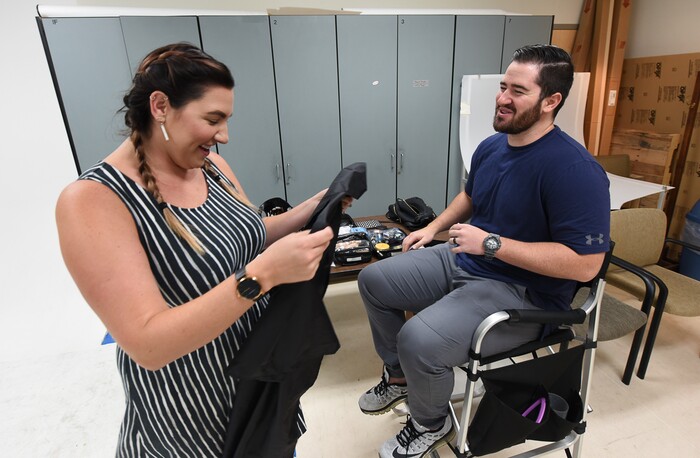 (Francisco Kjolseth | The Salt Lake Tribune) Makeup artist Kristen Packard jokes around with Brad Klekas of South Jordan, a BYU and Utah fan alike as he's willing to show his mutual admiration of both teams by stepping into the Tribune studio to get both colors in anticipation of the upcoming match up between the two rival teams on Saturday.