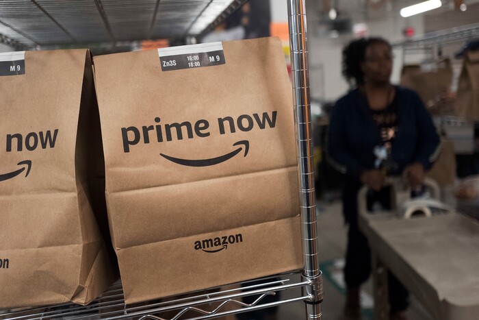 In this Wednesday, Dec. 20, 2017, photo, Prime Now customer orders are ready for delivery at the Amazon warehouse in New York. (AP Photo/Mark Lennihan)