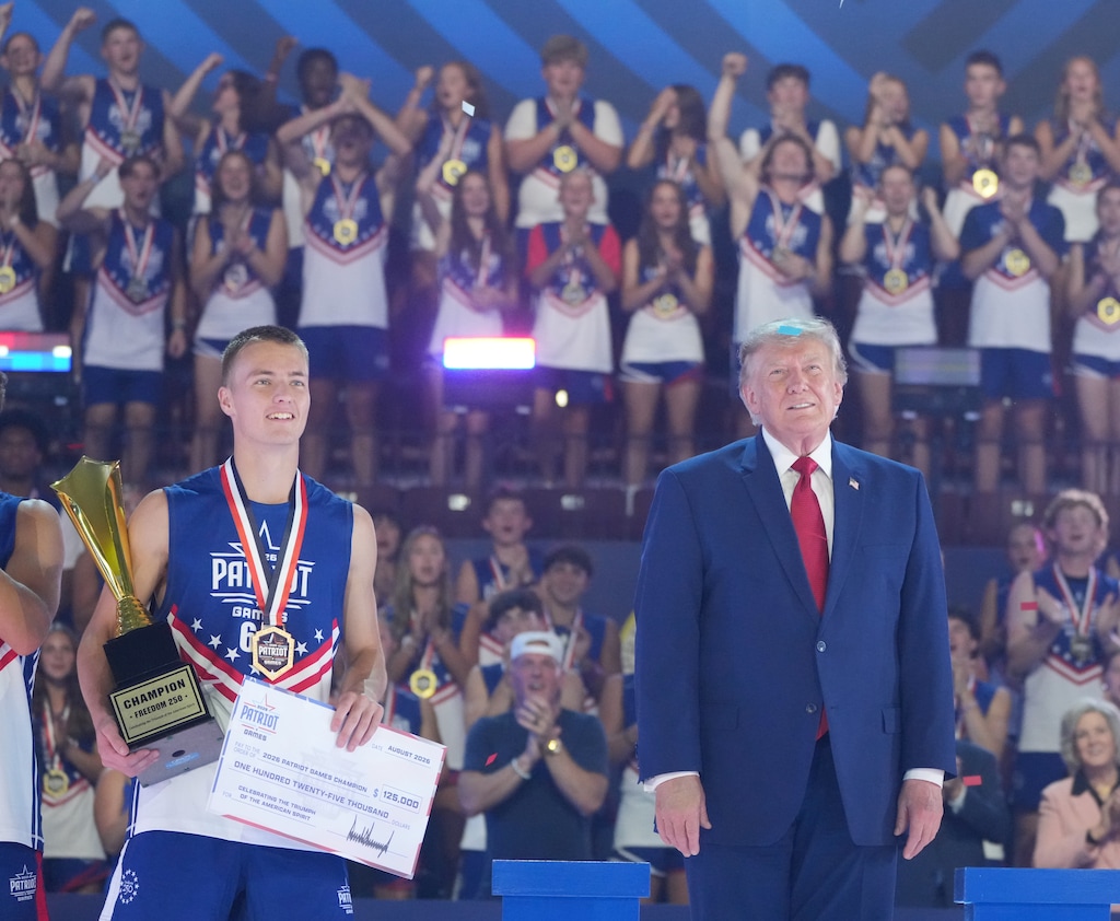 (Mark Schiefelbein | AP) President Donald Trump stands next to Rockwell Myers, a student-athlete from Utah Military Academy in St. George, Utah, at the closing ceremony of the Patriot Games at Spire Academy in Geneva, Ohio, on Aug. 11.