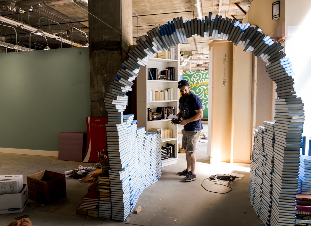 (Leah Hogsten  |  The Salt Lake Tribune) Co-designer and artist John Connors’ book archway leads visitors into another room from a hinged bookcase as part of the Love Letters Museum opening June 21, 2109. Love Letters is the newest 15,000-square-foot interactive art installation at The Gateway dedicated to the love of letters, as well as typography, books and literal love letters. “It is our attempt to use what we know best (letters, words, and art) to encourage each of our visitors to find and tell their own story. And to find the art in other's stories.” -Love Letters Museum. ​
