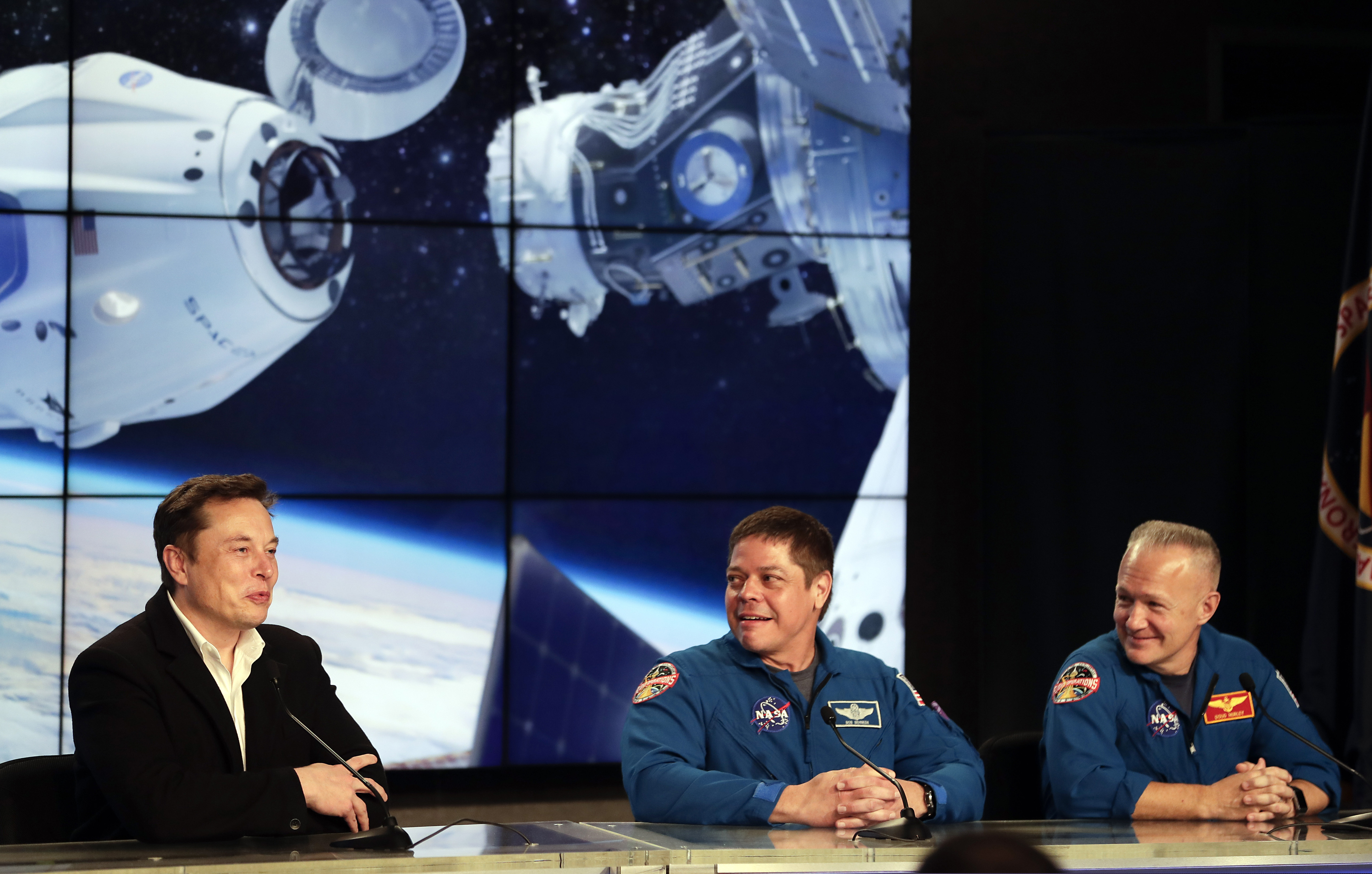 Elon Musk, left, CEO of SpaceX, speaks as NASA astronauts Bob Behnken, center, and Doug Hurley, right, listen during a news conference after the SpaceX Falcon 9 Demo-1 launch at the Kennedy Space Center in Cape Canaveral, Fla., Saturday, March 2, 2019. (AP Photo/John Raoux)