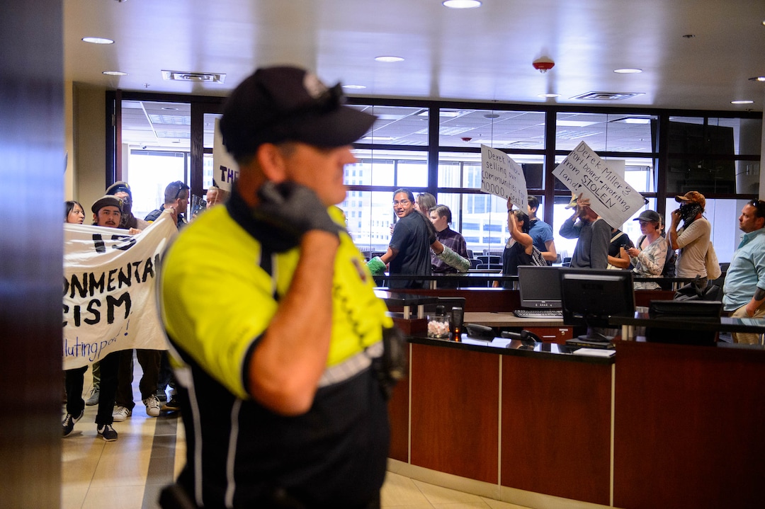 (Trent Nelson  |  The Salt Lake Tribune) Protesters occupy the Chamber of Commerce office in Salt Lake City on Tuesday, July 9, 2019. Dozens of people showed up to protest the proposed Inland Port and ended up clashing with police, resulting in temporary street closures and arrests.