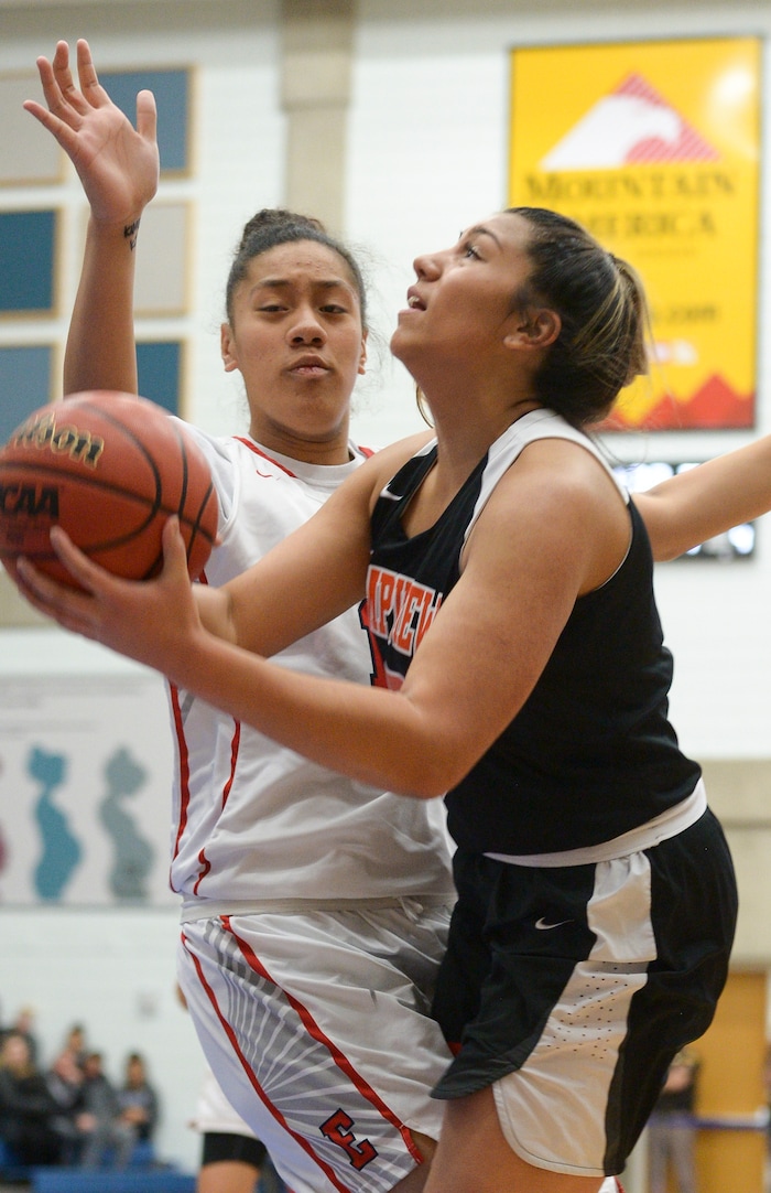 (Leah Hogsten  |  The Salt Lake Tribune) Timpview's Shalyn Fano (05) slips past East's Precious Faamausili (15).  East faces Timpview in the championship game of the 5A High School Girls' Basketball Tournament at SLCC in Taylorsville, Saturday, Feb. 24, 2018.