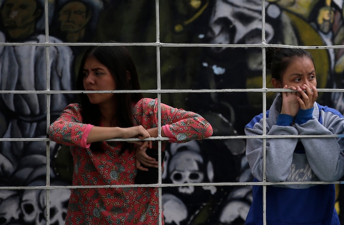 In this Aug. 25, 2017 photo, female students at a nursing school look on during a self-defense workshop led by Muay Thai practitioners in Nezahualcoyotl, Mexico state. At one class, students threw punches and kicks on an indoor soccer court _ and talked about learning to be afraid from a young age, as the killings of women plagues Mexico's most populous state. (AP Photo/Rebecca Blackwell)