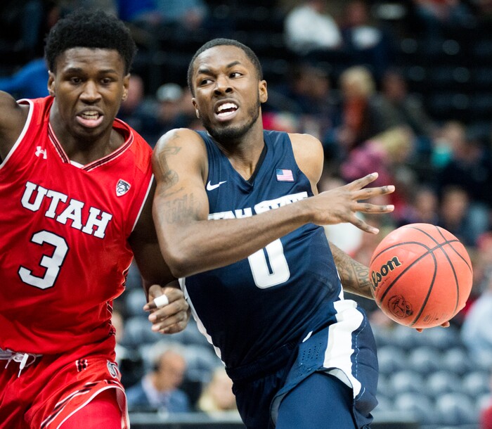 (Rick Egan  |  The Salt Lake Tribune)  Utah Utes forward Donnie Tillman (3) defends as Utah State Aggies guard DeAngelo Isby (0) takes the ball inside, in Beehive Classic basketball action at the Vivint SmartHome Arena, Saturday, December 9, 2017.