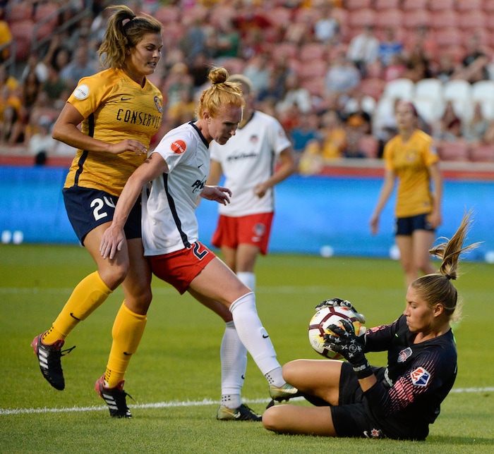 (Francisco Kjolseth  |  The Salt Lake Tribune)  Utah Royals FC hosts Washington Spirit, NWSL soccer at Rio Tinto Stadium in Sandy, Wed. Aug. 8, 2018. Utah Royals FC forward Katie Stengel (24) is blocked by Washington Spirit midfielder Tori Huster (23) during a drive against Washington Spirit goalkeeper Aubrey Bledsoe (1). 