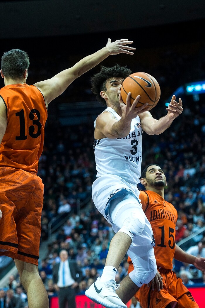 (Chris Detrick  |  The Salt Lake Tribune)  Brigham Young Cougars guard Elijah Bryant (3) shoots past Idaho State Bengals center Novak Topalovic (13) and Idaho State Bengals guard Brandon Boyd (15) during the game at the Marriott Center Thursday, December 21, 2017.  