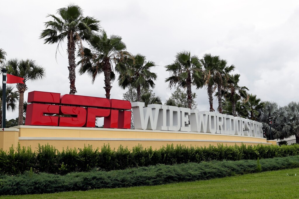 A sign marking the entrance to ESPN's Wide World of Sports at Walt Disney World is seen Wednesday, June 3, 2020, in Kissimmee, Fla. It is the site of the NBA bubble, where the Jazz begin play Thursday. (AP Photo/John Raoux)