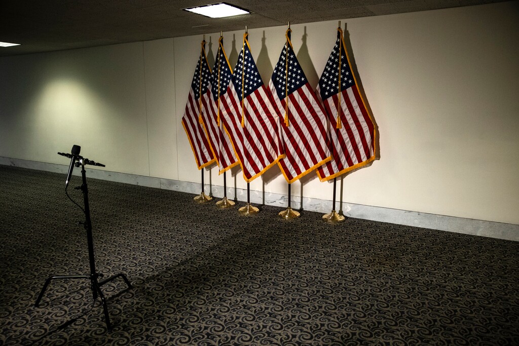 (Samuel Corum | The New York Times)
Flags and a microphone set up before a Republican luncheon in Washington, Oct. 25, 2020. If Republicans and Democrats go to the extremes in selecting their 2024 presidential candidate, there will be a third viable option, a unity ticket, which will appeal to members of both parties to combat this period of polarized dysfunction, the New York Times opinion columnist David Brooks writes.