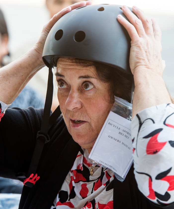 (Rick Egan  |  The Salt Lake Tribune)      Kaitlyn Murray, passes out free helmets courtesy of Bird scooters, at a news conference, about the new campaign with e-scooter companies Lime and Bird in an effort to help residents and visitors understand the rules of the sidewalk, Wednesday, Oct. 3, 2018.


