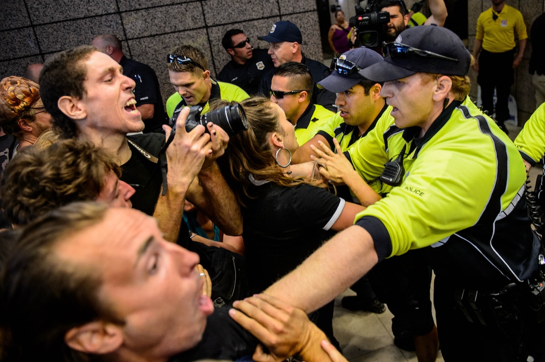 (Trent Nelson  |  The Salt Lake Tribune)  Police attempt to remove protesters occupying the Chamber of Commerce Building Salt Lake City on Tuesday, July 9, 2019. Dozens of people showed up to protest the proposed Inland Port and ended up clashing with police, resulting in temporary street closures and arrests.