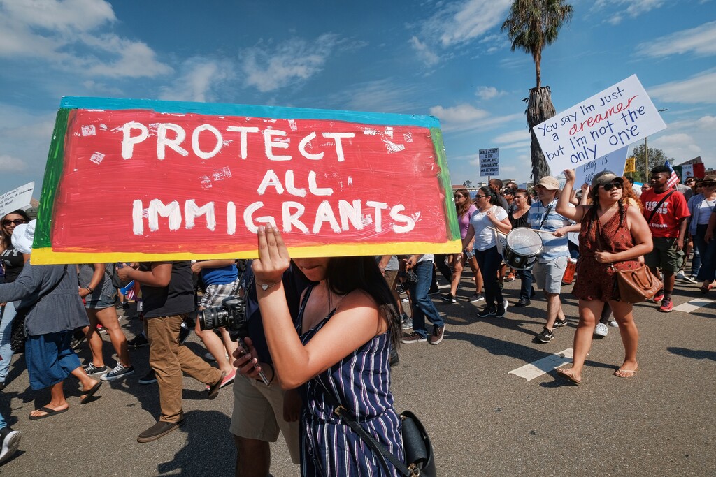 Supporters of the Deferred Action for Childhood Arrivals, or DACA chant slogans and carry signs while joining a Labor Day rally in downtown Los Angeles, Monday, Sept. 4, 2017. (AP Photo/Richard Vogel)