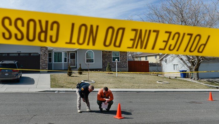 (Francisco Kjolseth | The Salt Lake Tribune) Investigators comb the scene where a Granite School District police officer shot a driver on Tuesday afternoon, March 20, 2018. While on patrol near Hunter High School, the officer noticed a car full of teenagers and smelled marijuana. When he approached the car lurched and he ended up on the hood. The driver was shot and four other teens in the car fled the scene.