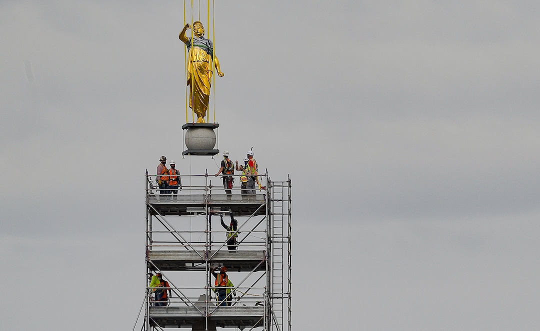 (Francisco Kjolseth  |  The Salt Lake Tribune) Crews work to remove the Angel Moroni statue atop the Salt Lake Temple of The Church of Jesus Christ of Latter-day Saints on Monday, May 18, 2020. The temple closed in December for seismic upgrades and sustained minor damager during the March 18, 2020, magnitude 5.7 earthquake when the trumpet held by the angel fell off and several smaller spire stones were displaced.