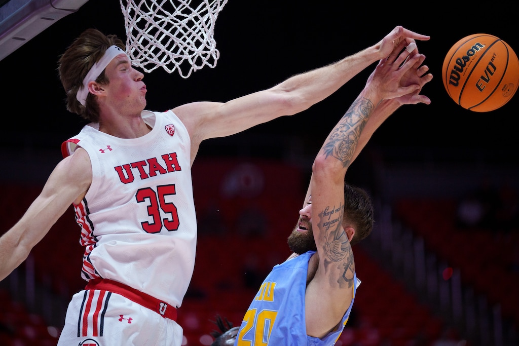 (Trent Nelson | The Salt Lake Tribune) Utah Utes center Branden Carlson (35) blocks a shot by Long Island University Sharks forward Jake Cook as the University of Utah hosts Long Island University, NCAA basketball in Salt Lake City on Monday, Nov. 7, 2022.