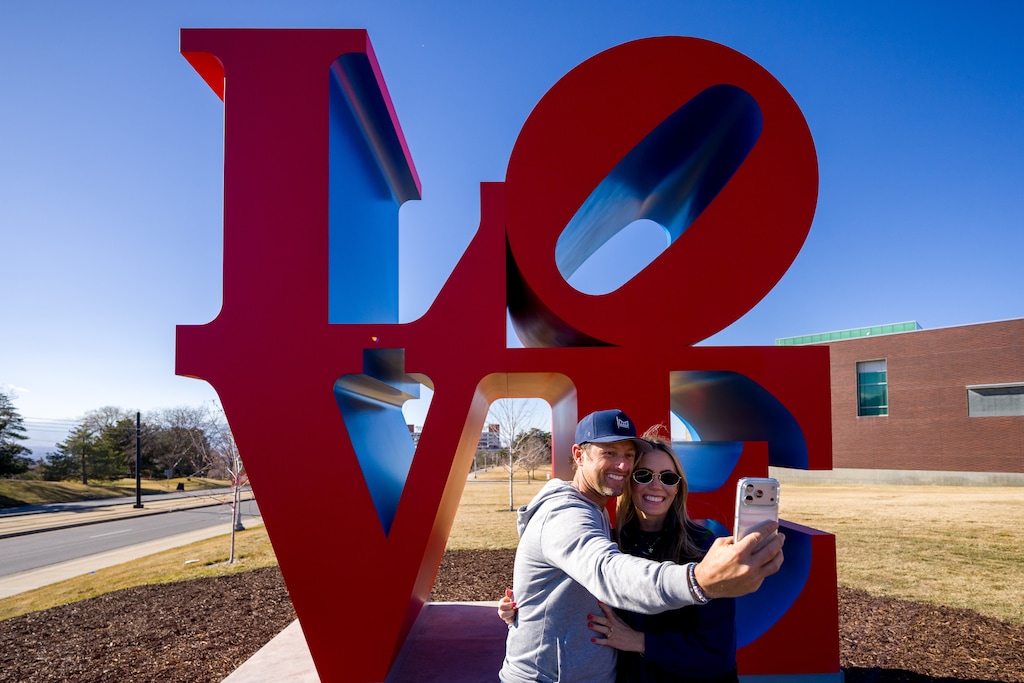 (Trent Nelson  |  The Salt Lake Tribune) Jason and Courtney Hawks take a selfie in front of Robert Indiana’s LOVE sculpture at the Utah Museum of Fine Arts in Salt Lake City on Saturday, Feb. 7, 2026.