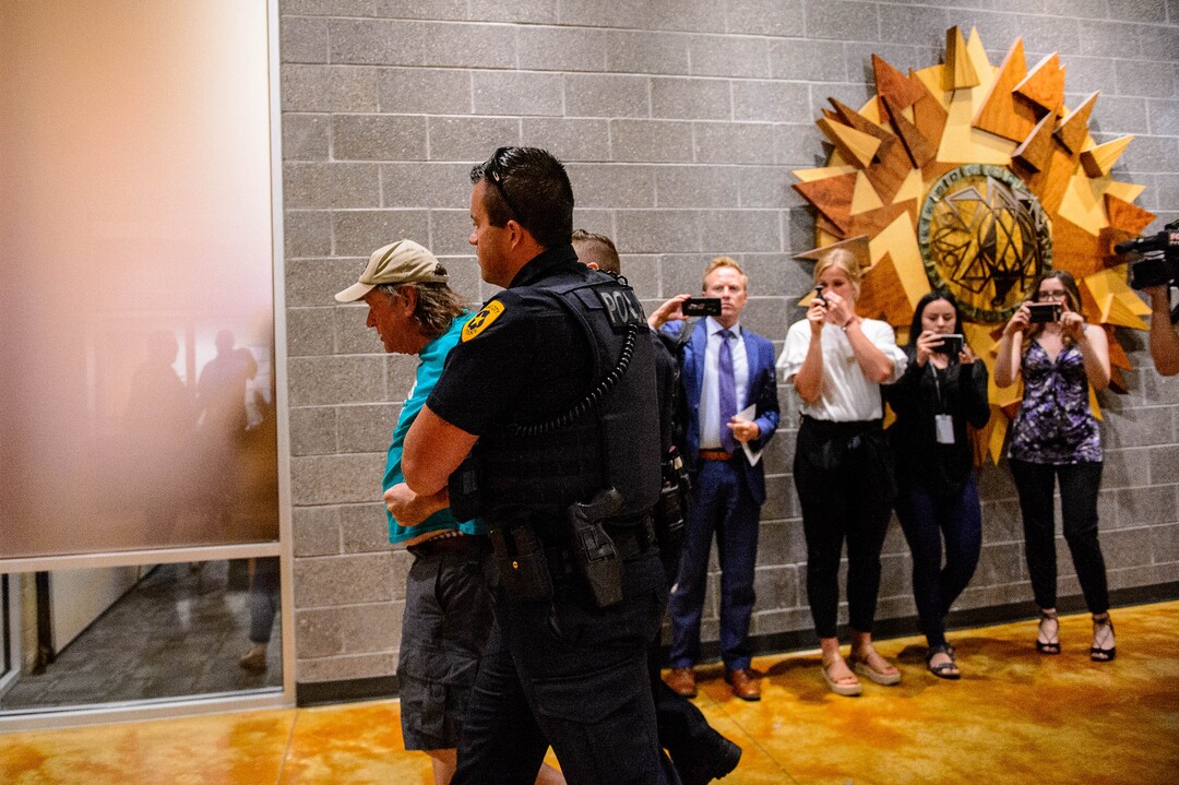 (Trent Nelson  |  The Salt Lake Tribune)  
A man is detained by police after a meeting of an inland port satellite working group was quickly canceled. The meeting was held at a police precinct in Salt Lake City on Wednesday, Aug. 14, 2019.